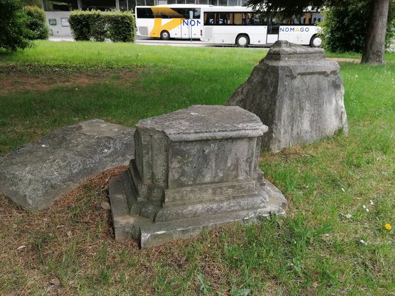 . Trije nagrobniki nekdanjega pokopališča v bližini avtobusne postaje.  &copy;Foto: Blaž Kosovel